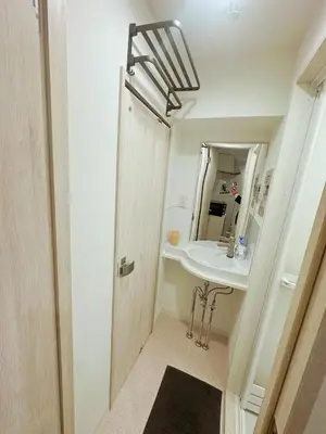 a bathroom with a sink and a mirror at \u6696\u71c8 DANTO inn 1F in Tokyo