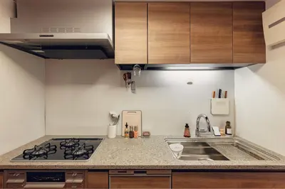 a kitchen with a sink and a stove at ACOE FUYU HATSUDAI - Re-design 2BR Modish Home in Shinjuku in Tokyo