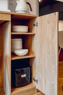a cupboard with plates and dishes inside of it at ACOE FUYU HATSUDAI - Re-design 2BR Modish Home in Shinjuku in Tokyo