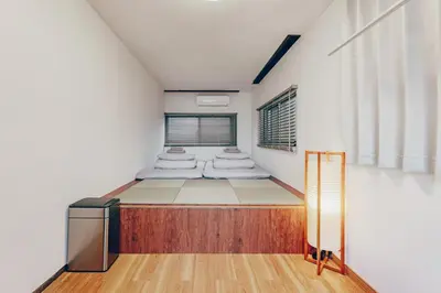 a bedroom with two beds in a room at ACOE FUYU HATSUDAI - Re-design 2BR Modish Home in Shinjuku in Tokyo