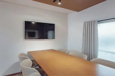 a conference room with a wooden table and chairs at ACOE FUYU HATSUDAI - Re-design 2BR Modish Home in Shinjuku in Tokyo