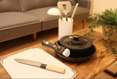 a table with a frying pan and a knife on it at AkasakaStay in Tokyo