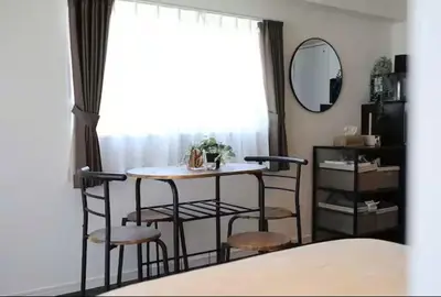 a table and chairs in a room with a window at AkasakaStay in Tokyo