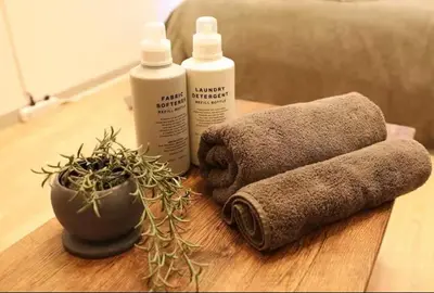 a wooden table with towels and a plant on it at AkasakaStay in Tokyo