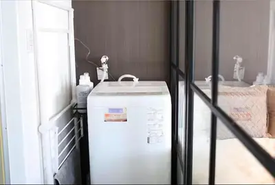 a white refrigerator in a room with a room with a table at AkasakaStay in Tokyo