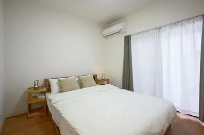 a bedroom with a large white bed and a window at BT House Nakano3-3min Shinjuku 15min Shibuya-Modern 2BR-Convenient access to airports in Tokyo