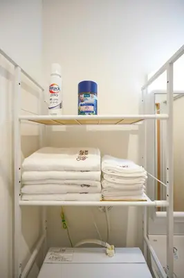a closet with white towels on a shelf at BT House Nakano3-3min Shinjuku 15min Shibuya-Modern 2BR-Convenient access to airports in Tokyo