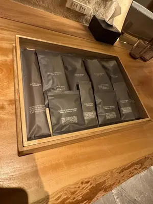 a box of black bags on a wooden table at sumica\u6d45\u8349\u82b1\u9ce5 in Tokyo