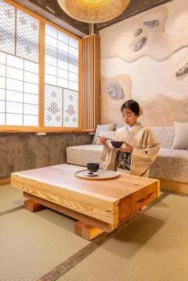 a woman in a living room with a coffee table at sumica\u6d45\u8349\u82b1\u9ce5 in Tokyo