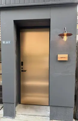 a door to a building with a sign on it at sumica\u98a8\u6708\u6d45\u8349 in Tokyo