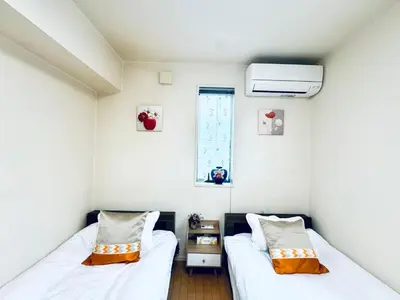 two beds in a small room with a window at XH-Ōgi, Adachi City 足立2dk-AD0042 in Tokyo