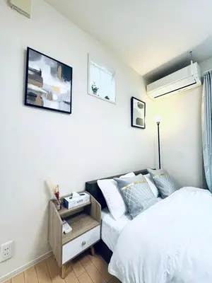 a bedroom with a bed and a night stand next to it at XH-Ōgi, Adachi City 足立2dk-AD0042 in Tokyo