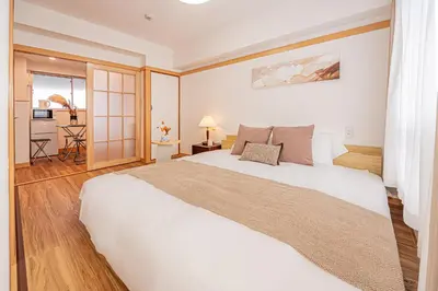 a bedroom with a large white bed in a room at Mi-HOTEL SHINOTSUKA in Tokyo