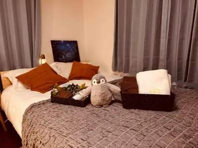 a stuffed animal sitting on top of a bed at Louis House\u897f\u65b0\u5bbf in Tokyo