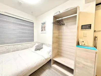 a bedroom with a bed and a walk in closet at Shinjuku downtown b3 in Tokyo