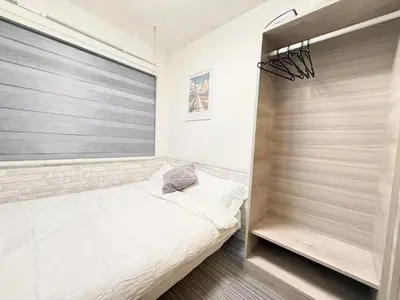 a bedroom with a bed and a window at Shinjuku downtown b3 in Tokyo