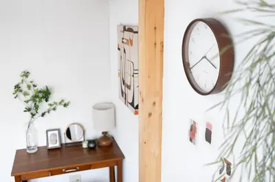 a clock hanging on a wall next to a table at Perfect Tokyo Location-Gueat for Sightseeing,SIeeps up to8! in Tokyo