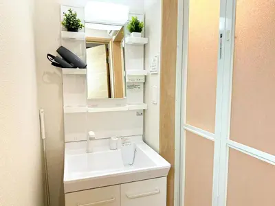 a bathroom with a sink and a mirror at Spacious 2BR TownHouse, Central Shinjuku City in Tokyo