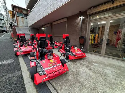 a row of red racing cars parked outside a building at Shinagawa Tokyo - Great access to Bullet Train and Haneda in Tokyo