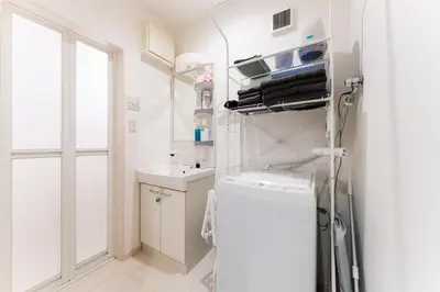 a small kitchen with a refrigerator and a sink at Shinagawa Tokyo - Great access to Bullet Train and Haneda in Tokyo