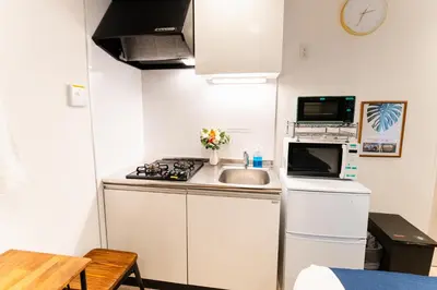a small kitchen with a sink and a stove at Shinagawa Tokyo - Great access to Bullet Train and Haneda in Tokyo