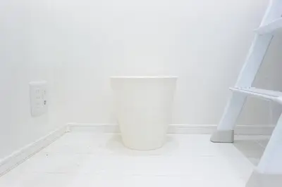 a white room with a staircase and a shelf at Monthly Studio G2 in Tokyo