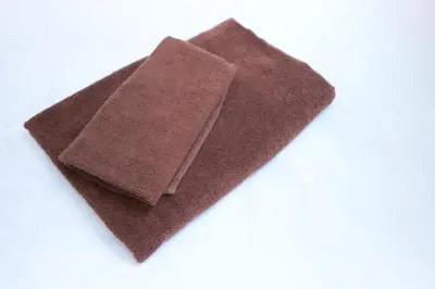 a close up of a brown towel on a white background at Monthly Studio G2 in Tokyo