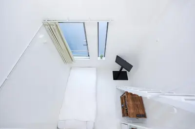 a white room with a window and towels at Monthly Studio G2 in Tokyo