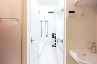 a white bathroom with a sink and a mirror at Monthly Studio G2 in Tokyo