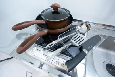 a tea pot and utensils on a glass table at Monthly Studio G2 in Tokyo
