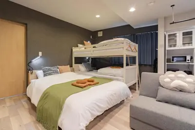 a bedroom with two beds and a bunk bed at \u30a2\u30f3\u30c9\u30b9\u30c6\u30a4\u5f25\u751f\u753a4\u4e01\u76ee101 in Tokyo