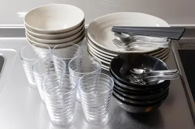 a counter with plates and cups and forks and spoons at \u30a2\u30f3\u30c9\u30b9\u30c6\u30a4\u5f25\u751f\u753a4\u4e01\u76ee101 in Tokyo