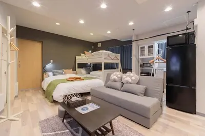 a bedroom with a bed and a couch and a bed at \u30a2\u30f3\u30c9\u30b9\u30c6\u30a4\u5f25\u751f\u753a4\u4e01\u76ee101 in Tokyo