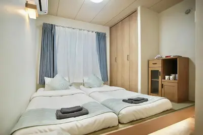 a bedroom with two beds and a window at Shin-Okachimachi I Metro 6 minutes I Direct To Airport in Tokyo