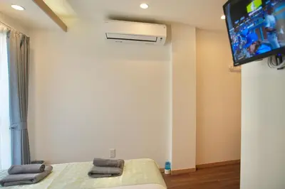 a bedroom with a bed and a tv on the wall at Shin-Okachimachi I Metro 6 minutes I Direct To Airport in Tokyo