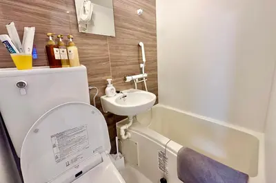 a small bathroom with a toilet and a sink at Shin-Okachimachi I Metro 6 minutes I Direct To Airport in Tokyo