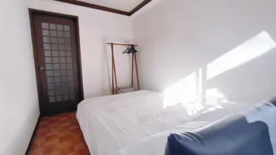 a bedroom with a white bed and a door at Shinjuku 2bed rooms sunny apart ment#2\u5ba41\u5385\u9633\u5149\u516c\u5bd3#\u9ad8\u901f\u65e0\u9650\u5236\u7f51\u8def2#1 in Tokyo