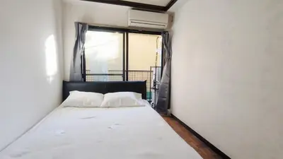 a white bed in a room with a window at Shinjuku 2bed rooms sunny apart ment#2\u5ba41\u5385\u9633\u5149\u516c\u5bd3#\u9ad8\u901f\u65e0\u9650\u5236\u7f51\u8def2#1 in Tokyo