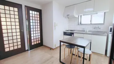 a small kitchen with a table and a sink at Shinjuku 2bed rooms sunny apart ment#2\u5ba41\u5385\u9633\u5149\u516c\u5bd3#\u9ad8\u901f\u65e0\u9650\u5236\u7f51\u8def2#1 in Tokyo