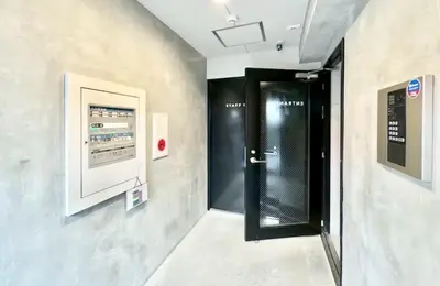 a hallway with a black door in a wall at Newly opened! Shibuya Mishuku Sky Terrace in Tokyo