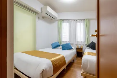 a bedroom with two beds and a window at -Belmazon meguro402- 7 minutes to Shibuya Station in Tokyo