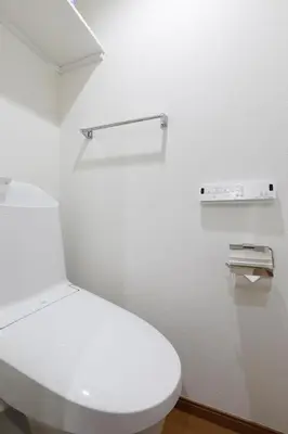 a white bathroom with a toilet and a shelf at LIFE TOWN Nishiarai II in Tokyo