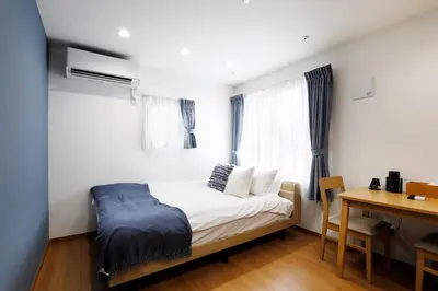 a small bedroom with a bed and a desk at LIFE TOWN Nishiarai II in Tokyo