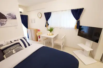a bedroom with a bed and a table and a tv at 12 minutes by train to Skytree, 4 min to station on foot, 1F, 20square meter in Tokyo