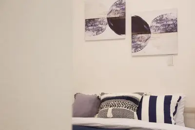 a living room with a couch and three pictures on the wall at 12 minutes by train to Skytree, 4 min to station on foot, 1F, 20square meter in Tokyo