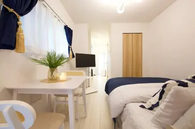 a bedroom with a bed and a table and a desk at 12 minutes by train to Skytree, 4 min to station on foot, 1F, 20square meter in Tokyo