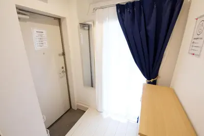 a room with a blue curtain and a door at 12 minutes by train to Skytree, 4 min to station on foot, 1F, 20square meter in Tokyo
