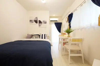 a small bedroom with a bed and a table at 12 minutes by train to Skytree, 4 min to station on foot, 1F, 20square meter in Tokyo