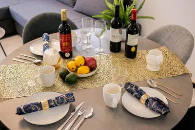 a table with wine bottles and plates of fruit on it at \u5927\u5cf6Villa in Tokyo
