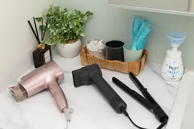 a hair dryer on a counter with plants and other items at Shibuya Base in Tokyo